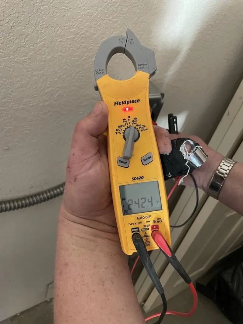 Voltage testing with clamp meter during Electrical Installation Services in Maryville